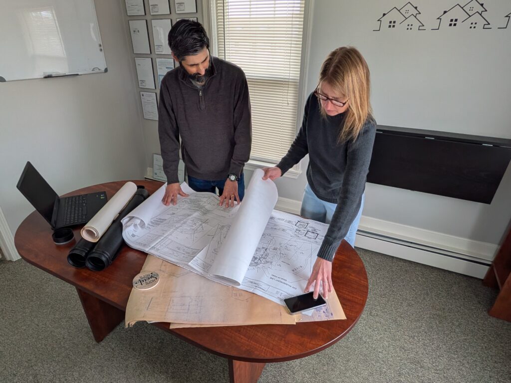 Phil & Heidi reviewing building/site plans at the office