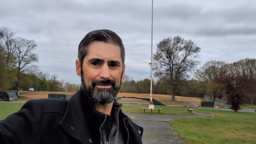 Phil in front of new property site